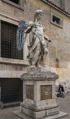 Fototapeta na wymiar Old statue of Michael the Archangel in yard of Castle Saint Ange