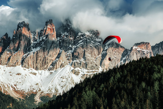 Paraglider flying near high mountains. Dolomites, Italy