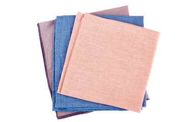 Stack of three colorful textile napkins on white