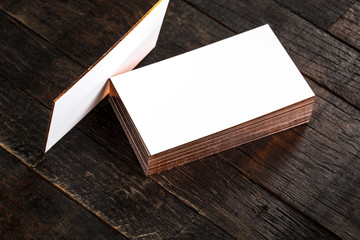 blank business cards with golden hot stamping edges on wooden background