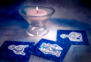 Astrology concept with zodiac water signs Cancer, Scorpion, Pisces and candle 