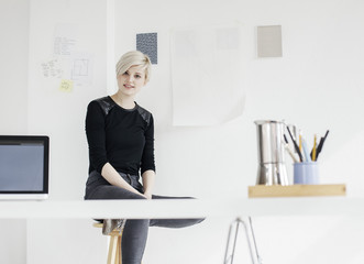 Young designer working at her desk