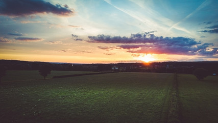 Drone flight and topview in the summer sunset above the are of Aachen with its flields, forest and...