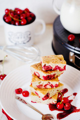 Cake, dessert and pastries, biscuit pie with cherry, raspberries and milk on a light background 