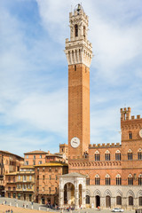 Fototapeta na wymiar Palazzo Pubblico with the clock tower in Siena, Italy