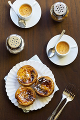 Pasteis de Nata or Pasteis de Belém (Portuguese Custard Tarts) with Espresso on Table