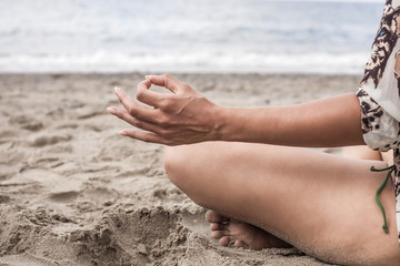 Woman detail portrait meditating on the beach