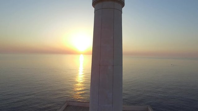 Lighthouse at dawn - aerial view 4k