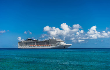 Cruise ship in crystal blue water with a pirate and pirate flag on the front