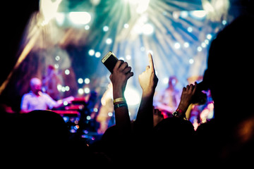 crowd with raised hands at concert - summer music festival