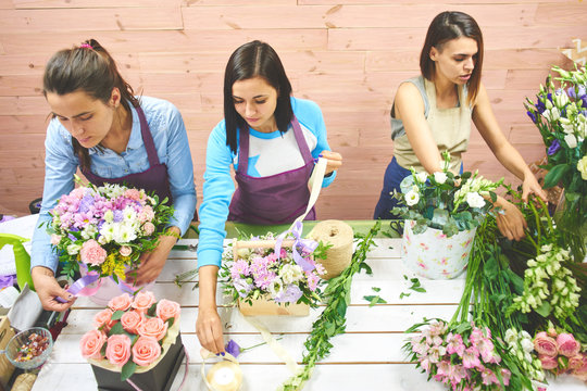 Three girls florist working with flowers