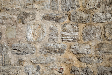 Pattern of the ancient style stone wall with cement.