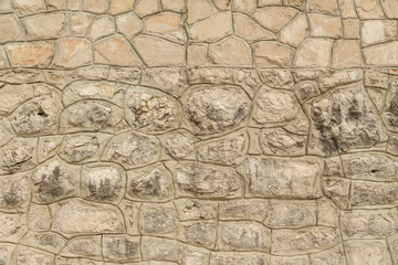 Fototapeta na wymiar Pattern of the ancient style stone wall with cement.