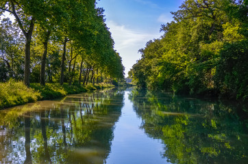 Fototapeta na wymiar Beautiful Canal du Midi, sycamore trees reflection in water, Southern France 