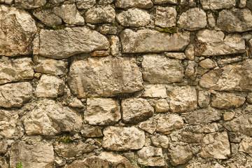 Pattern of the ancient style stone wall with cement.