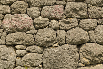Pattern of the ancient style stone wall with cement.