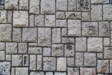 Pattern of the ancient style stone wall with cement.