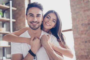 True love. Beautiful latino couple of young lovers are hugging indoors at home, with love and tenderness, wearing casual clothes