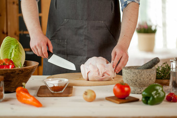 male preparing chicken for cooking