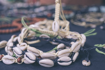 Variery of different woman accessories with shells on a Bali handmade market. Bali, Indonesia.