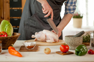 Obraz na płótnie Canvas male preparing chicken for cooking