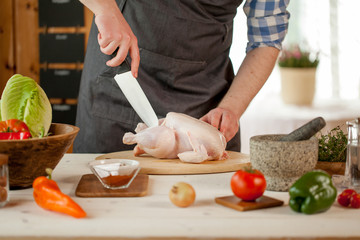 male preparing chicken for cooking