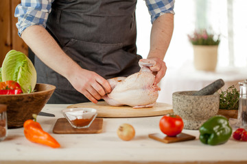 male preparing chicken for cooking