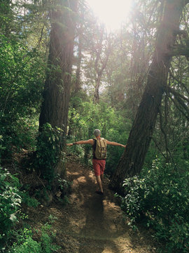 Man standing between trees in Cloudcroft, New Mexico