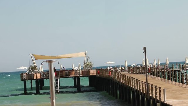 Pier on the Turkish coast, cafe on the pier, waves, good weather