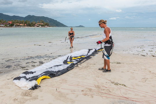 Surfers Preparing Their Kite