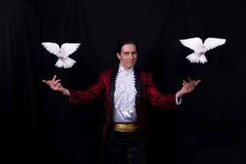 The magician with a two flying white Doves