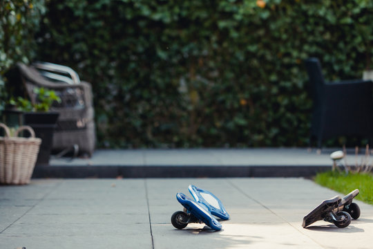 Two abandoned skateboards lying in the garden