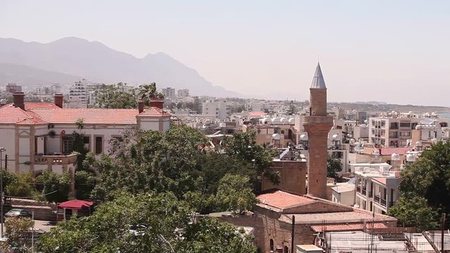 View of the Arab city by a mosque, The Arab city near the sea, the minaret in the Arab city, the Muslim, the Muslim city, east, Arabian town near the sea, against the backdrop of mountains, top view