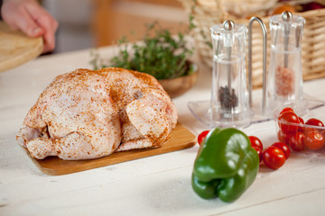 male preparing chicken for cooking