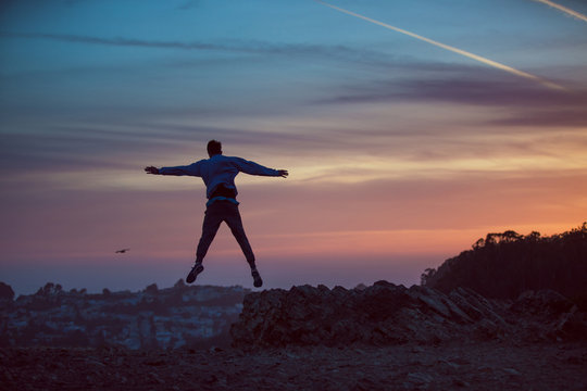 Man jumping into sunset