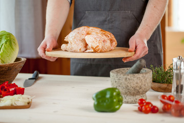 male preparing chicken for cooking