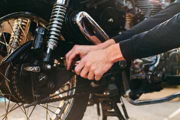 man repairing motorcycle