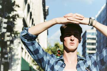 Chiseled hunk shading his eyes from the bright sun