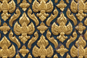 Antique Thai traditional art wood carved pattern on temple door.
