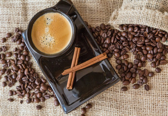 Coffee beans, a cup of coffee, cinnamon