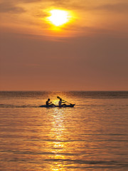 Fototapeta premium Double kayakers paddle on a sunset ocean, Ko Kut, Thailand