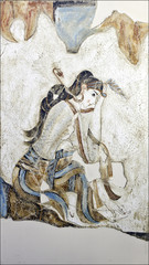 Painted woman in unidentified mural on wall in ruins of  Fira, Santorini, Greece © William