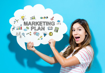 Marketing Plan text with young woman holding a speech bubble on a blue background