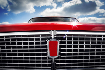 Details shot of a bright red soviet retro car's front grill