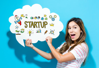 Start Up text with young woman holding a speech bubble on a blue background