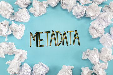 Metadata text with crumpled paper balls on a blue background