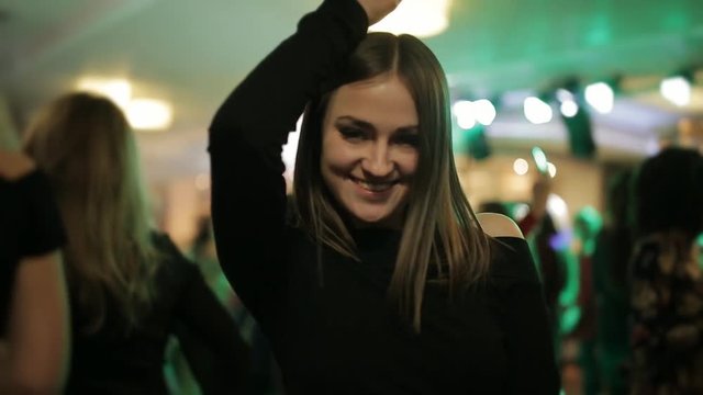 A girl dances in a nightclub