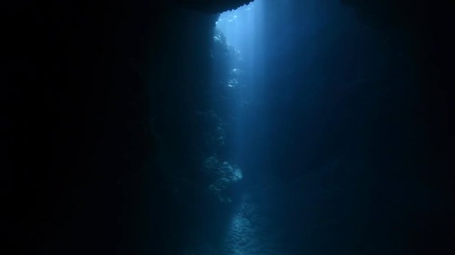 Rays of sunlight shining into the underwater cave