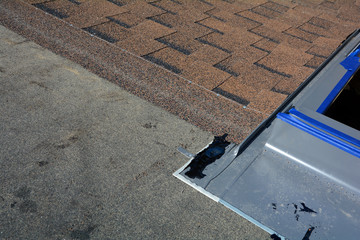 Fototapeta premium Installing Skylights in new house. Bitumen roof shingles. Vapor barrier and Waterproofing. Unfinished roof.