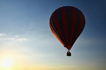 Colorful hot air balloon is flying at sunset. Natural colorful background with sky.